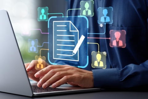 A person types on a laptop with a digital graphic overlay showing interconnected profile icons linked to a central document icon.